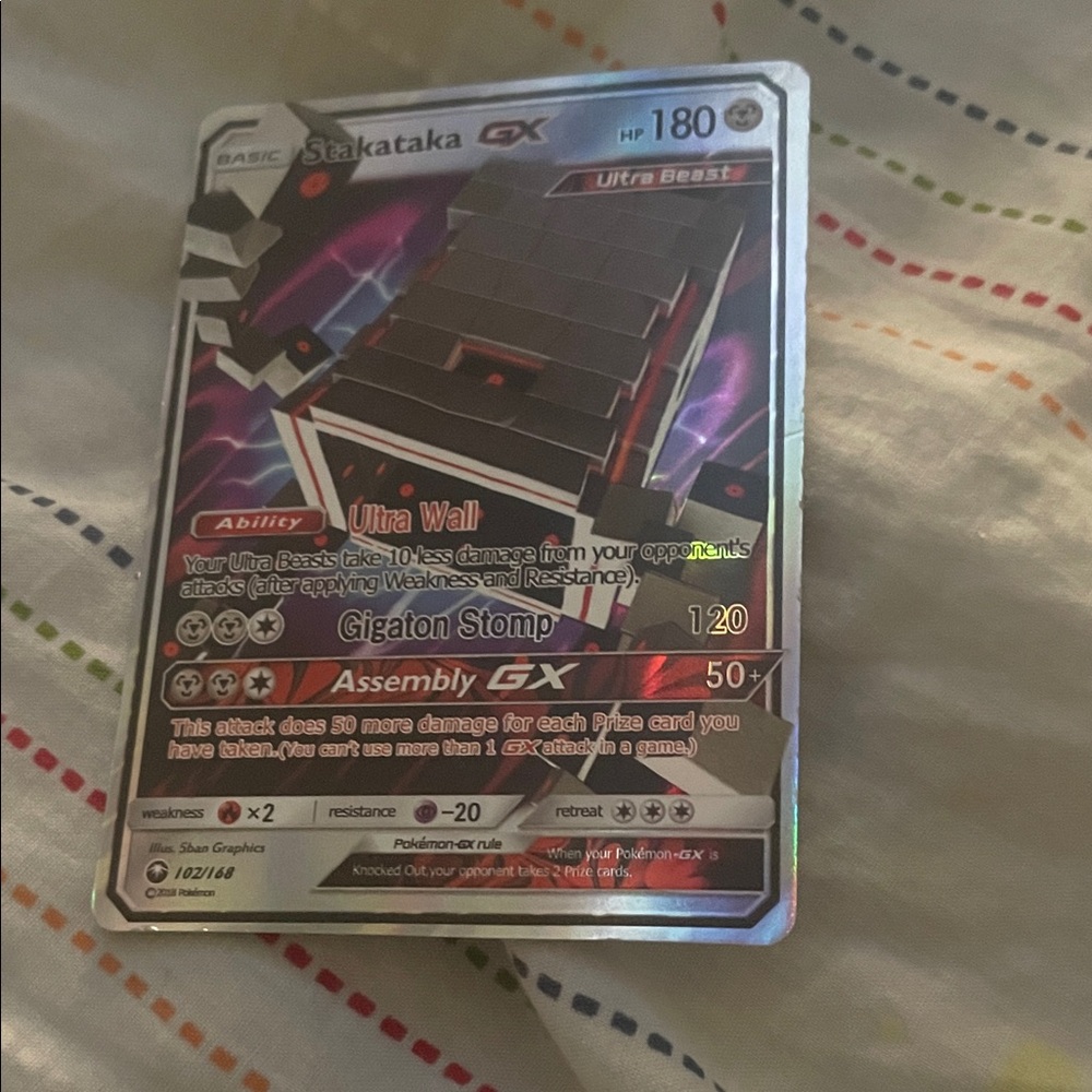 Pokemon Stakataka GX Card with Red and Black Hues